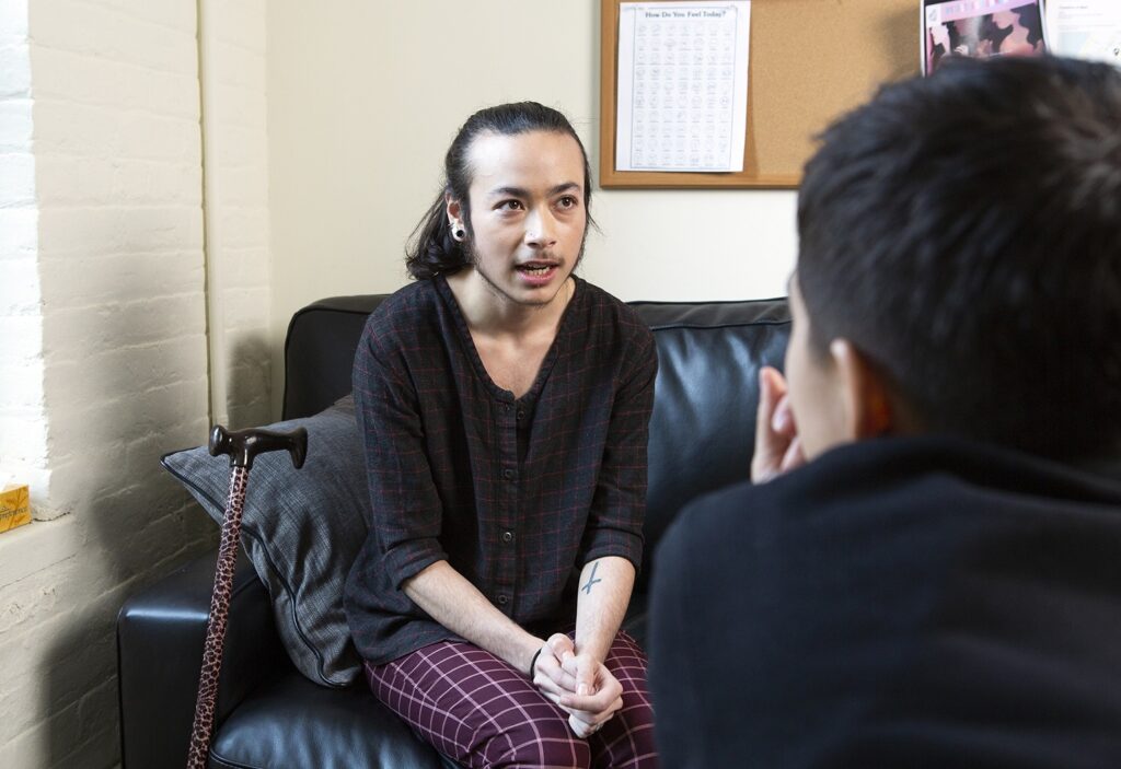 A gender queer person talking to a therapist