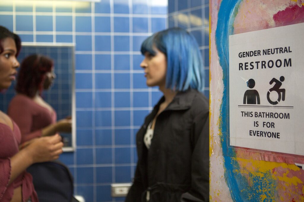 Two Young People In A Gender Neutral Bathroom